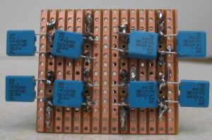 Underside of two rectifier bridges built onto a piece of stripboard.